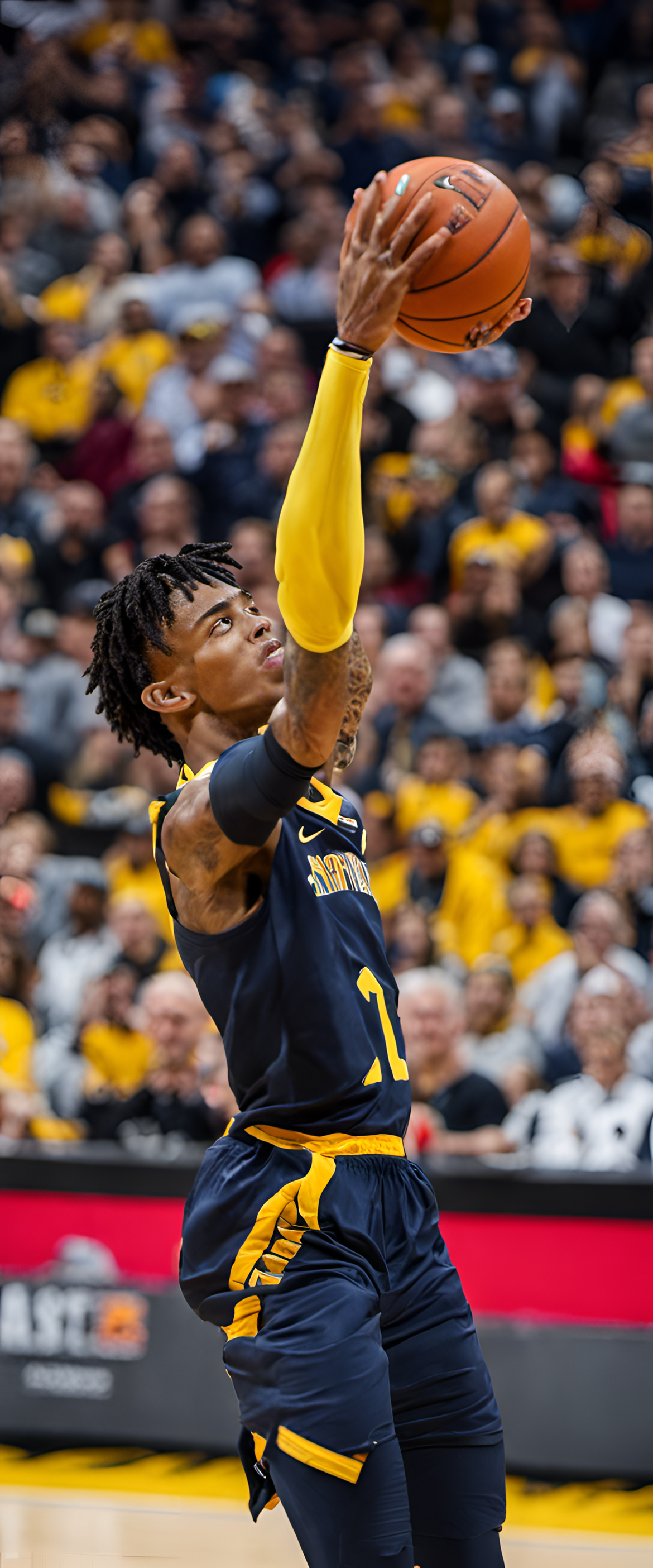 Ja Morant basketball player in action, dribbling the ball, ready to make a play.