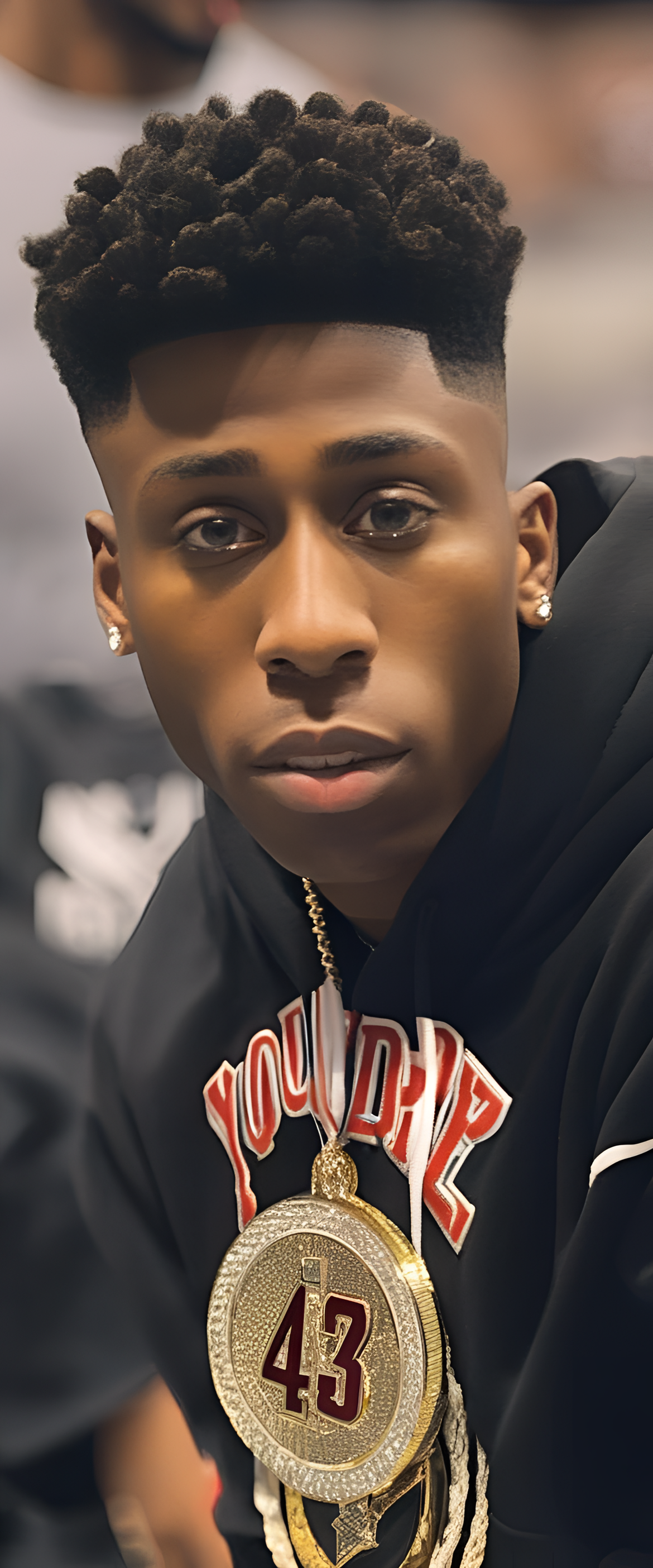 NBA YoungBoy portrait with intense gaze.