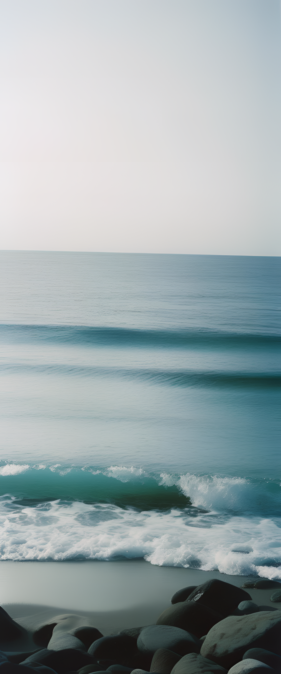 Vibrant blue ocean waves crashing against golden sandy beach.