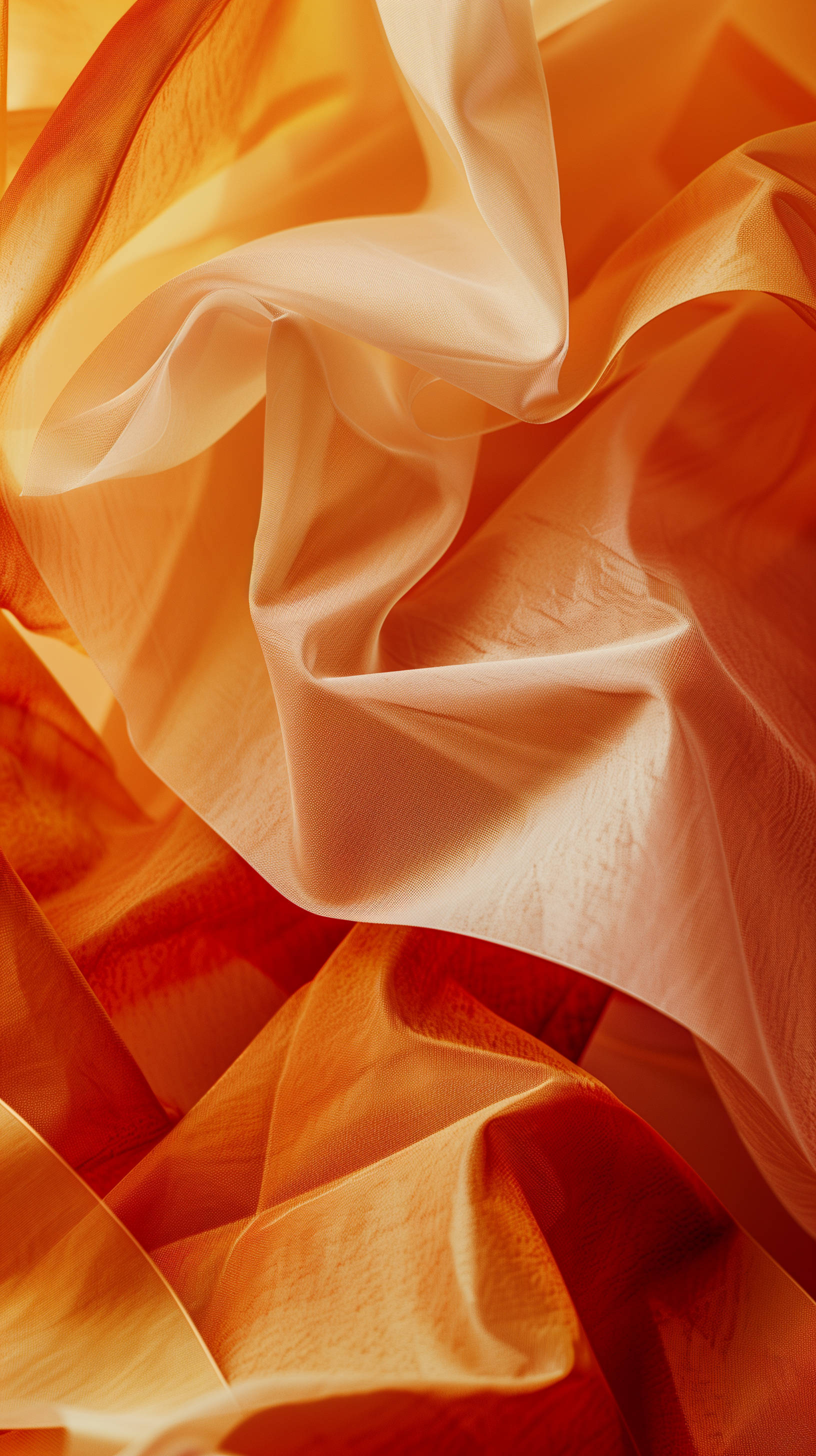 An abstract composition of softly folded fabric in warm shades of orange and cream, creating a dynamic and textured surface perfect for phone wallpaper.